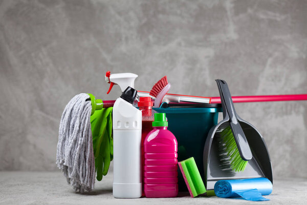 Cleaning supplies on grey background