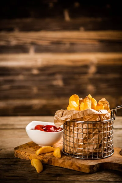 French fries on wooden table — Stock Photo, Image