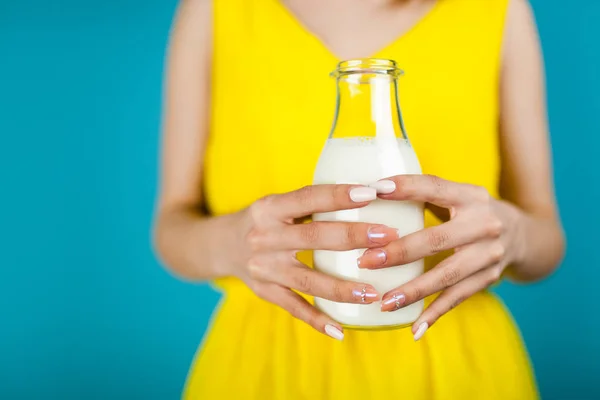 Woman holding a bottle of milk — Stock Photo, Image