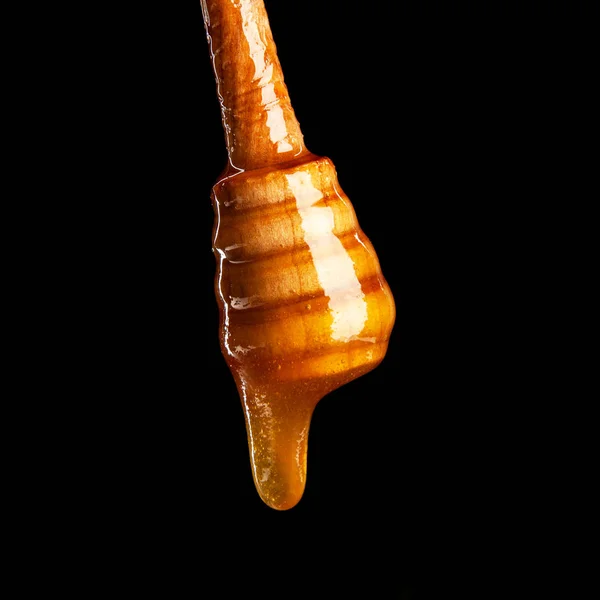 Honung skopa på svart bakgrund — Stockfoto