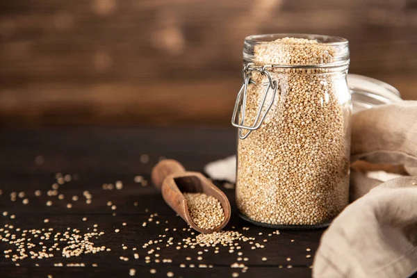 Raw quinoa seeds in a glass jar — Stock Photo, Image