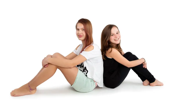 Two Teenage Girls Sitting Back Back — Stock Photo, Image