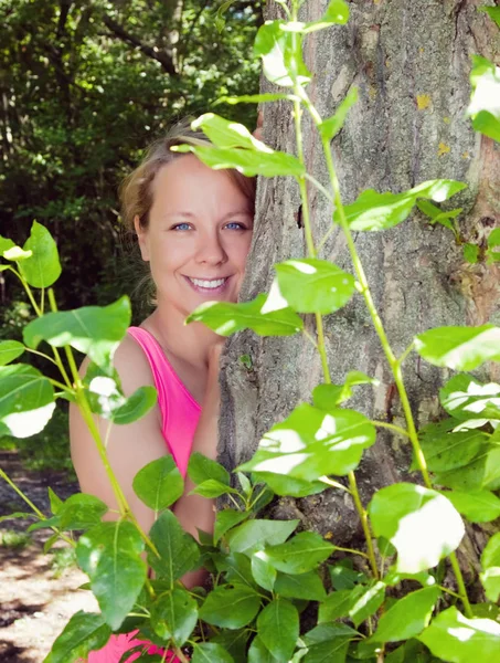 güzel kadın bir ağacın arkasına gizlenmiş