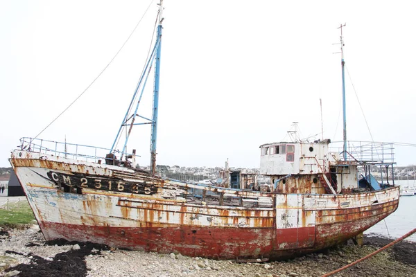 Camaret sur mer adlı düşük tide Fransa limanında terk edilmiş eski paslı balıkçı tekneleri