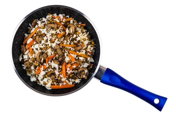 Cooked mix from mushroom, lentils, rice in frying pan isolated on white background. Top view