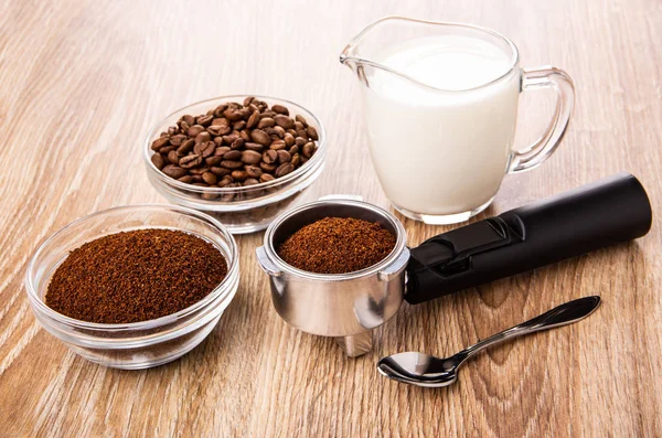 Bowls with ground coffee and coffee beans, holder from coffee ma