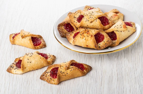 Shortbread cookies with jam in saucer, cookies on table