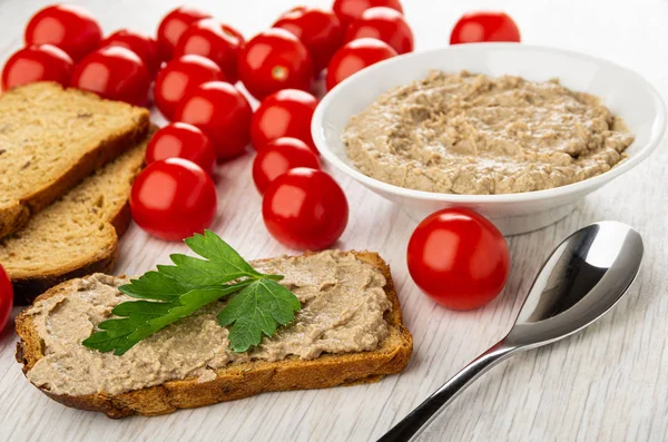 Bread, tomatoes, bowl with liver pate, sandwich with pate and pa