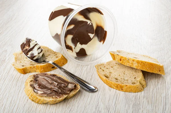Overturned jar with chocolate paste, slices of bread, sandwich,