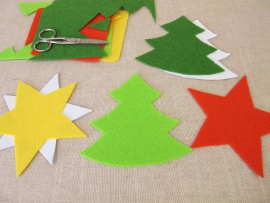 Handmade christmas stars and christmas trees made of felt clipart