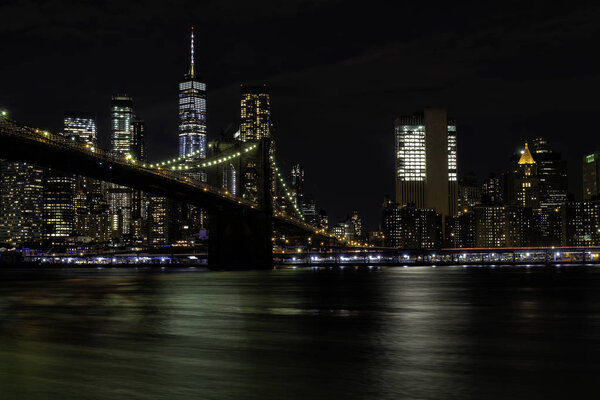 Brooklyn bridge with lower Manhattan skyline in the background shot from across the East river