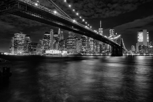 East river flowing under the Brooklyn bridge with lower Manhattan skyline in the background