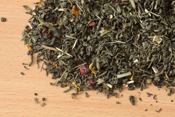 Yeşil çay ile arka plan. Kurutulmuş yeşil çay masada bırakır. Dökülen çay yaprakları.