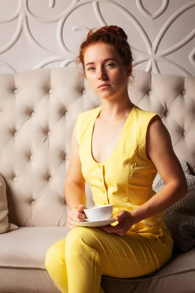 Beautiful Woman Yellow Suit Cup Sitting Couch — Stock Photo, Image