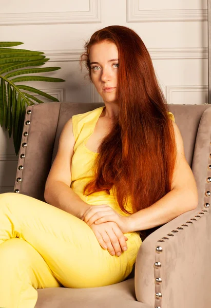Mooie Vrouw Een Geel Pak Zittend Een Chai — Stockfoto