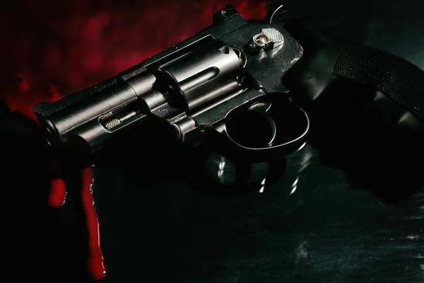 Revolver and blood on black — Stock Photo, Image