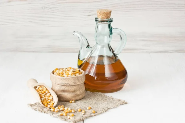 Aceite Maíz Jarra Vidrio Granos Maíz Secos Sobre Fondo Madera — Foto de Stock