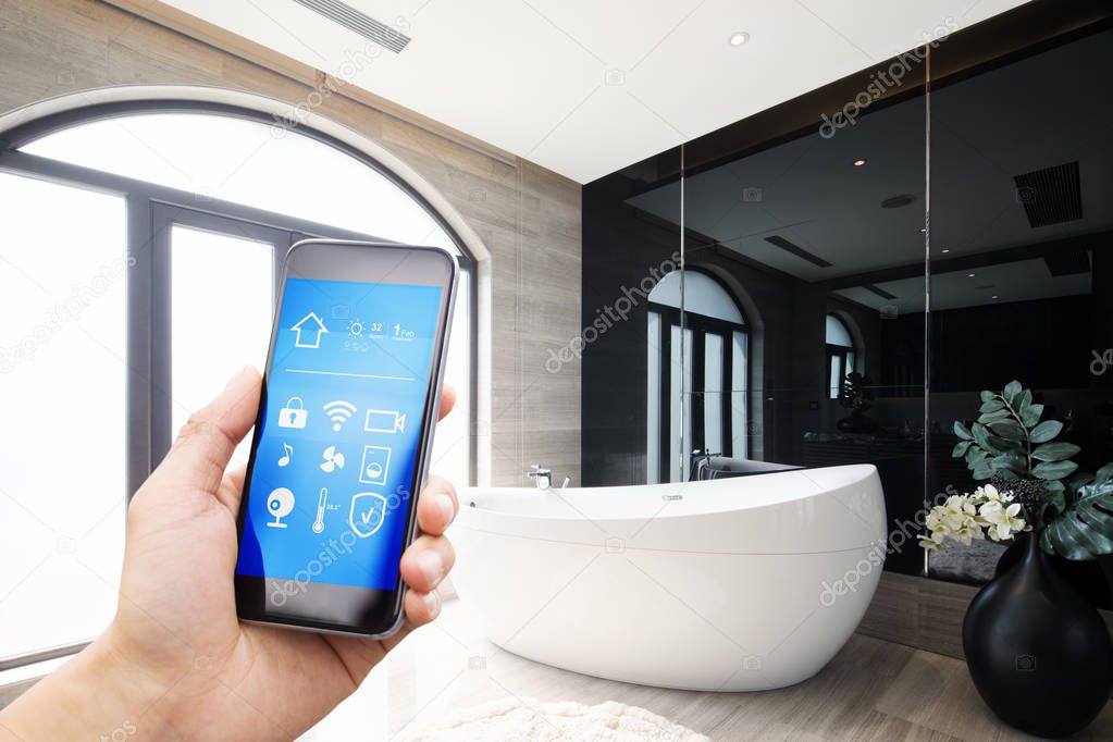 mobile phone with smart home app in modern bathroom