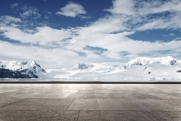 empty asphalt road with snow mountains