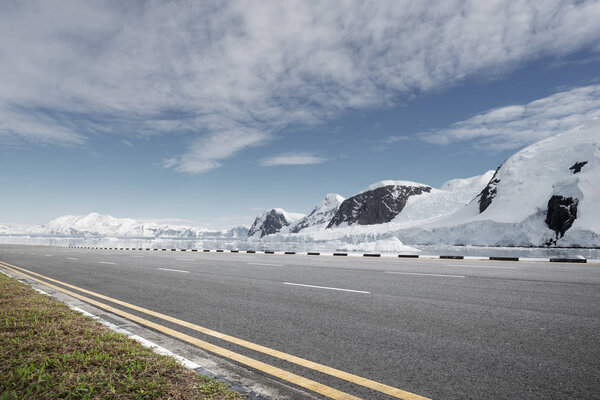 empty asphalt road with snow mountains