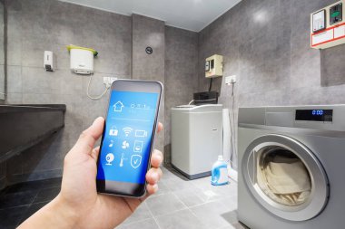 mobile phone with smart home app in modern washhouse clipart