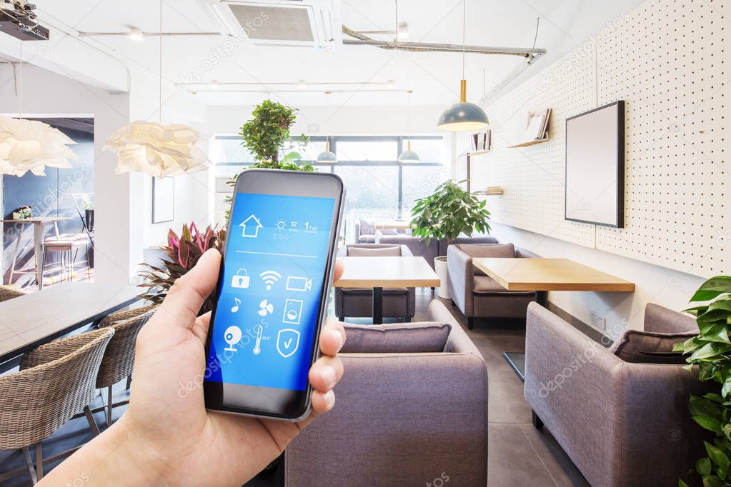 mobile phone with smart home app in modern living room