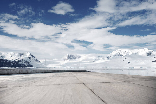 empty brick ground with snow mountains as background