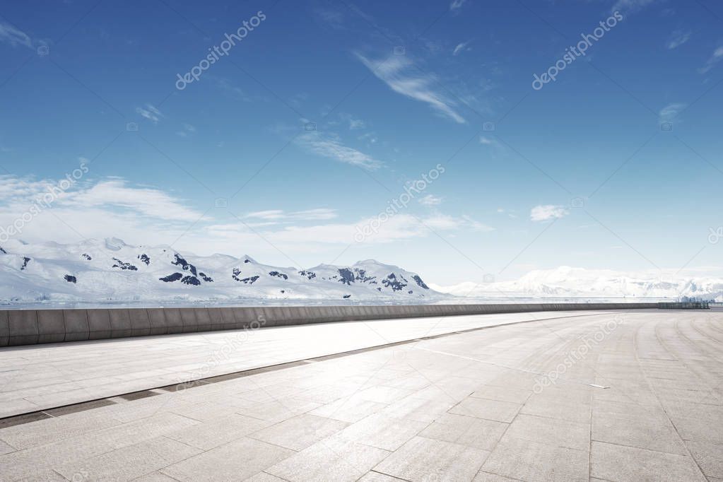 empty brick ground with snow mountains as background