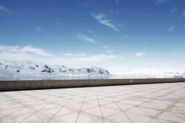 empty brick ground with snow mountains as background