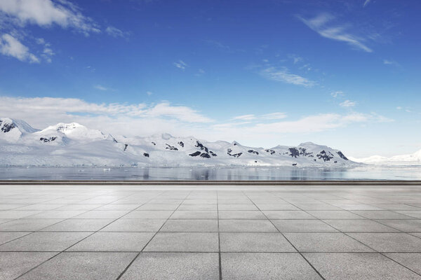 empty brick ground with snow mountains as background