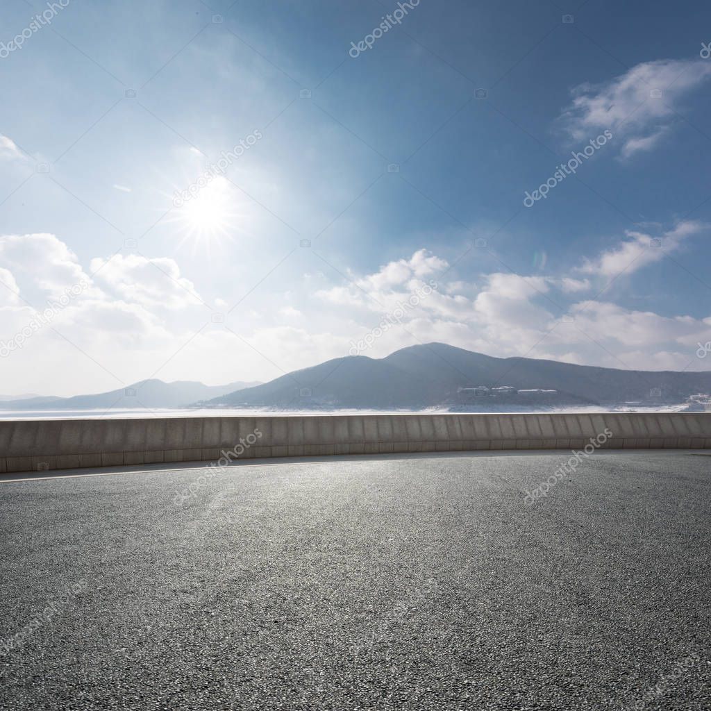 highway through mountains with blue sky 
