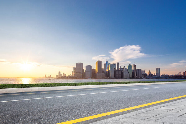 empty asphalt road through modern city 