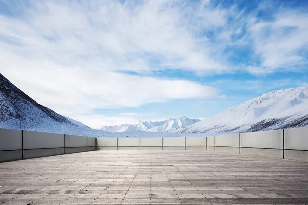 empty floor with snow mountains