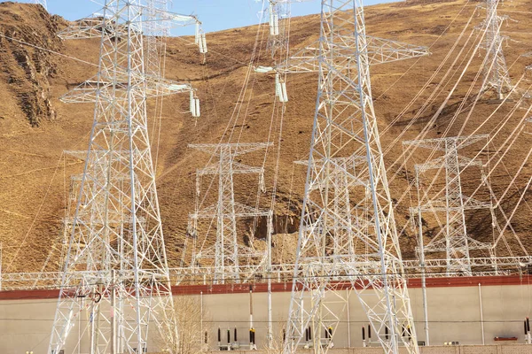 High voltage transmission tower or power towers (electricity pylon) and electrical distribution substation