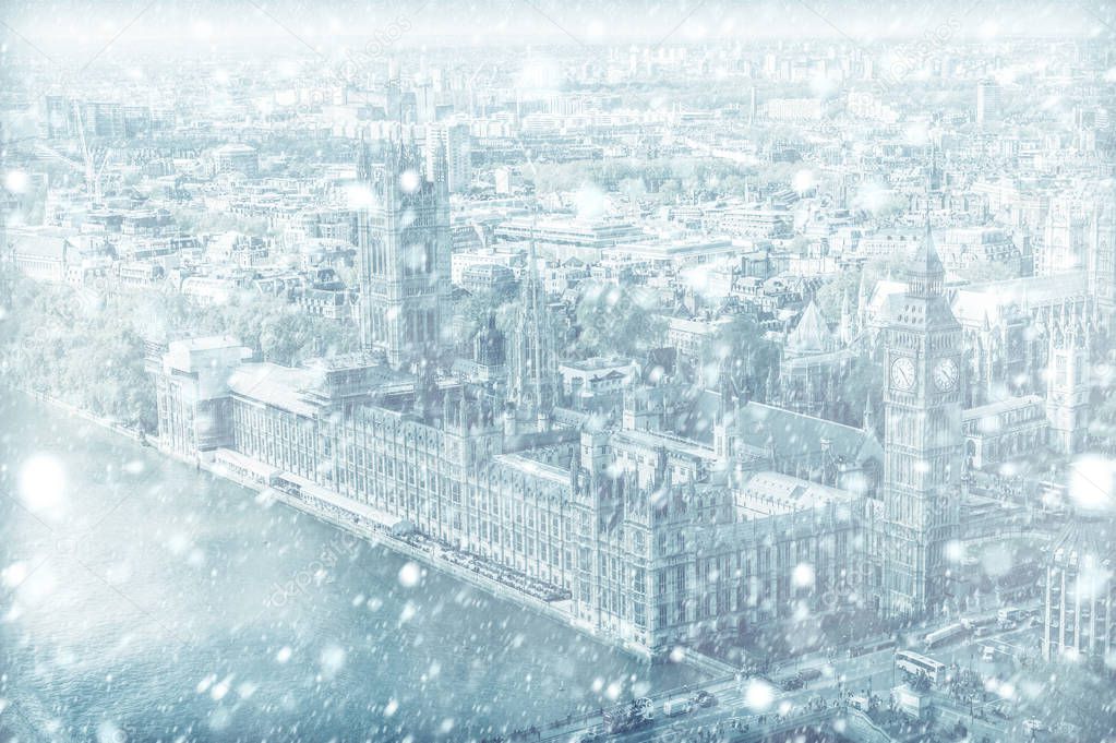 View of House of Parliament with Thames river in London with snow