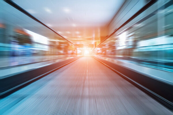 Escalator motion blur in airport , light from exit