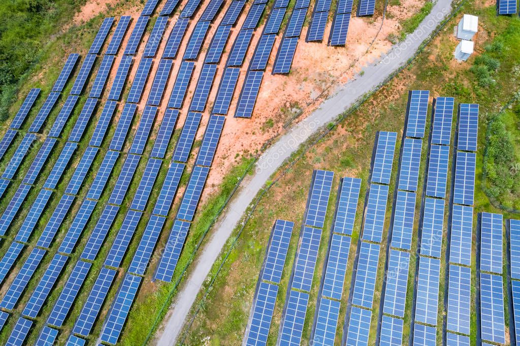 Aerial view of photovoltaic panels on hillside , renewable energy for solar power