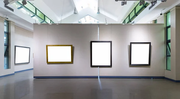 blank frames fro painting or photography on exhibition wall in a room