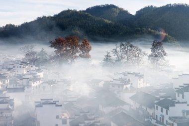 morning mist wreathed the ancient shicheng village, beautiful rural scenery in wuyuan county, jiangxi province clipart