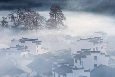 mist covered scene in shicheng village, late autumn landscape of wuyuan,  the most beautiful countryside in China clipart
