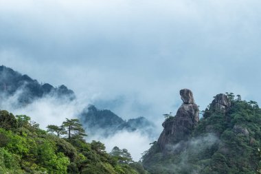 mount sanqing landscape, oriental goddess with cloud fog, located northeast of shangrao city in jiangxi province, China clipart