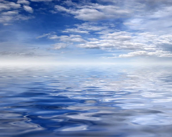 reflection of a blue cloudy sky in the ocean surface