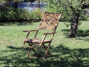 ahşap şezlong rahatlamak için yeşil çim çim üzerinde kalır