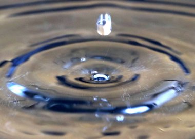 Bir varil petrolün yüzeyinde su sıçramalarına ve damla