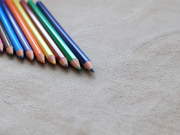 一套彩色铅笔绘制在一块真正的皮革 — 图库照片