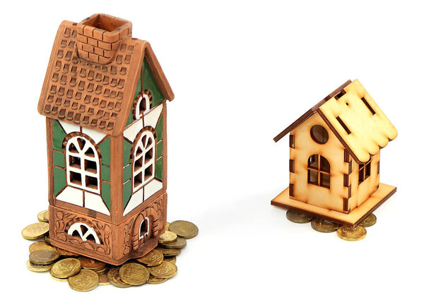 brick house and a wooden hut on a pile of Russian coins as a symbol of the difference of investments