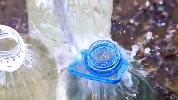 Befüllung Von Plastikflaschen Mit Sauberem Trinkwasser Aus Einem Gummischlauch — Stockvideo