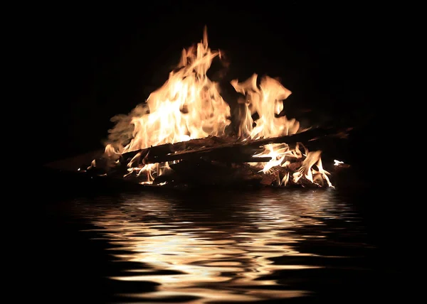 bright fire on the ruins of the transport floating on the water