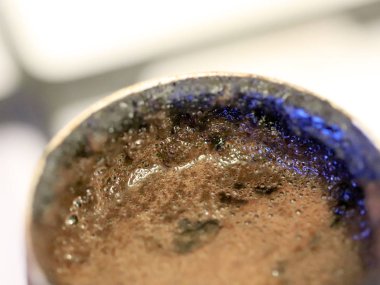 coffee foam on the surface of the drink during preparation