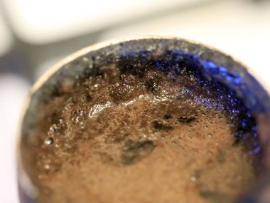 coffee foam on the surface of the drink during preparation